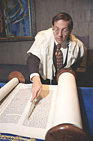 Jewish Holidays:  Rabbi reading Torah